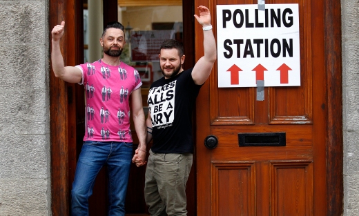 Partners Adrian, left and Shane, arrive to cast their vote at a polling station in Drogheda, Ireland, Friday, May 22, 2015.  (AP Photo/Peter Morrison)